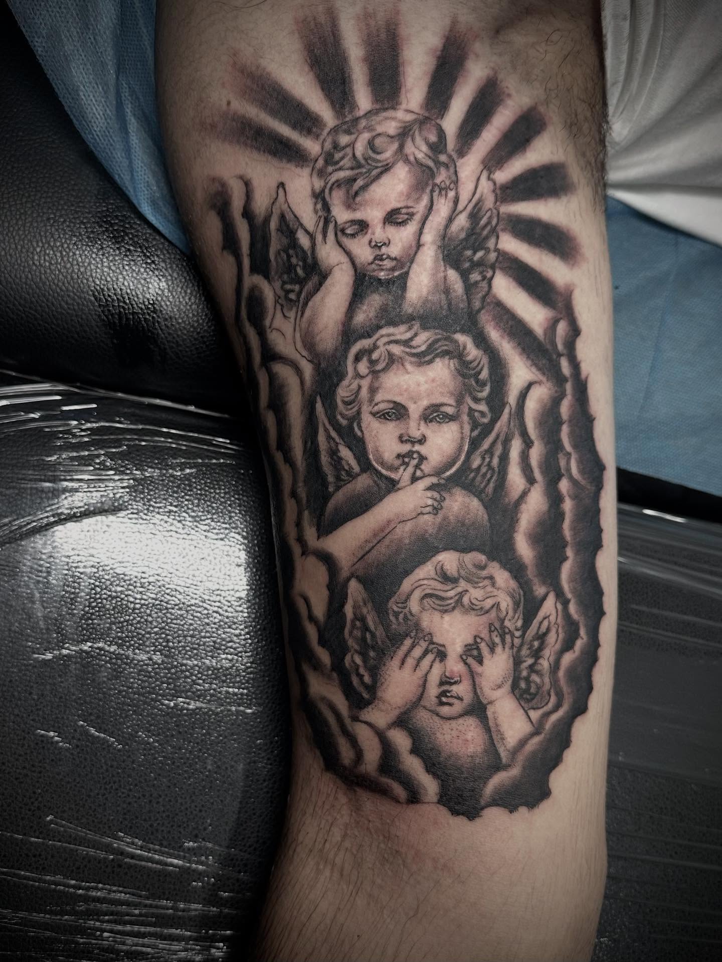 Cherubs black and grey tattoo on the forearm by mia's tattoo, Los Angeles, California