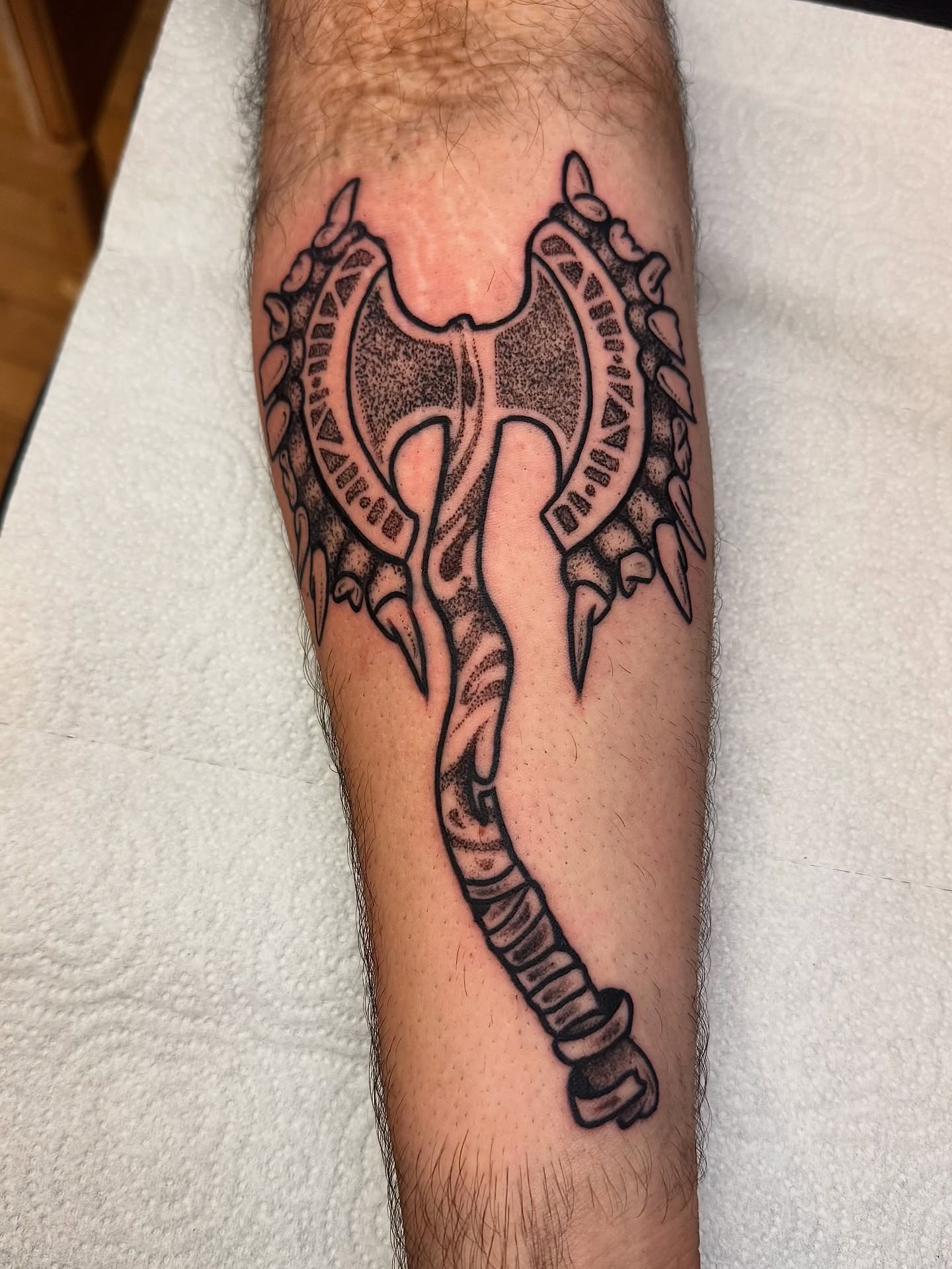 Ax dotwork tattoo on the forearm by Brandon
