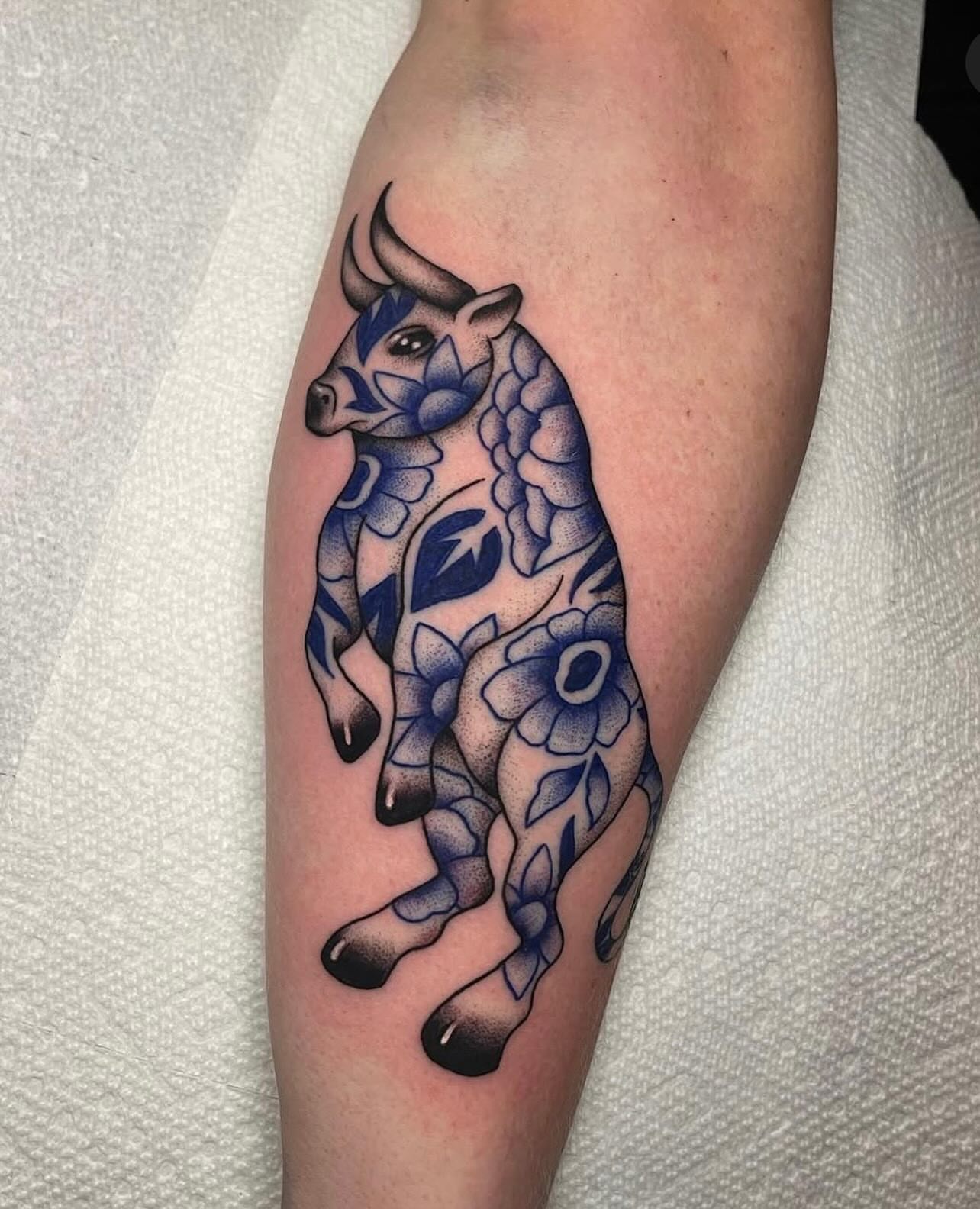 Bull with floral patterns dotwork tattoo on the forearm by Marqui Watling