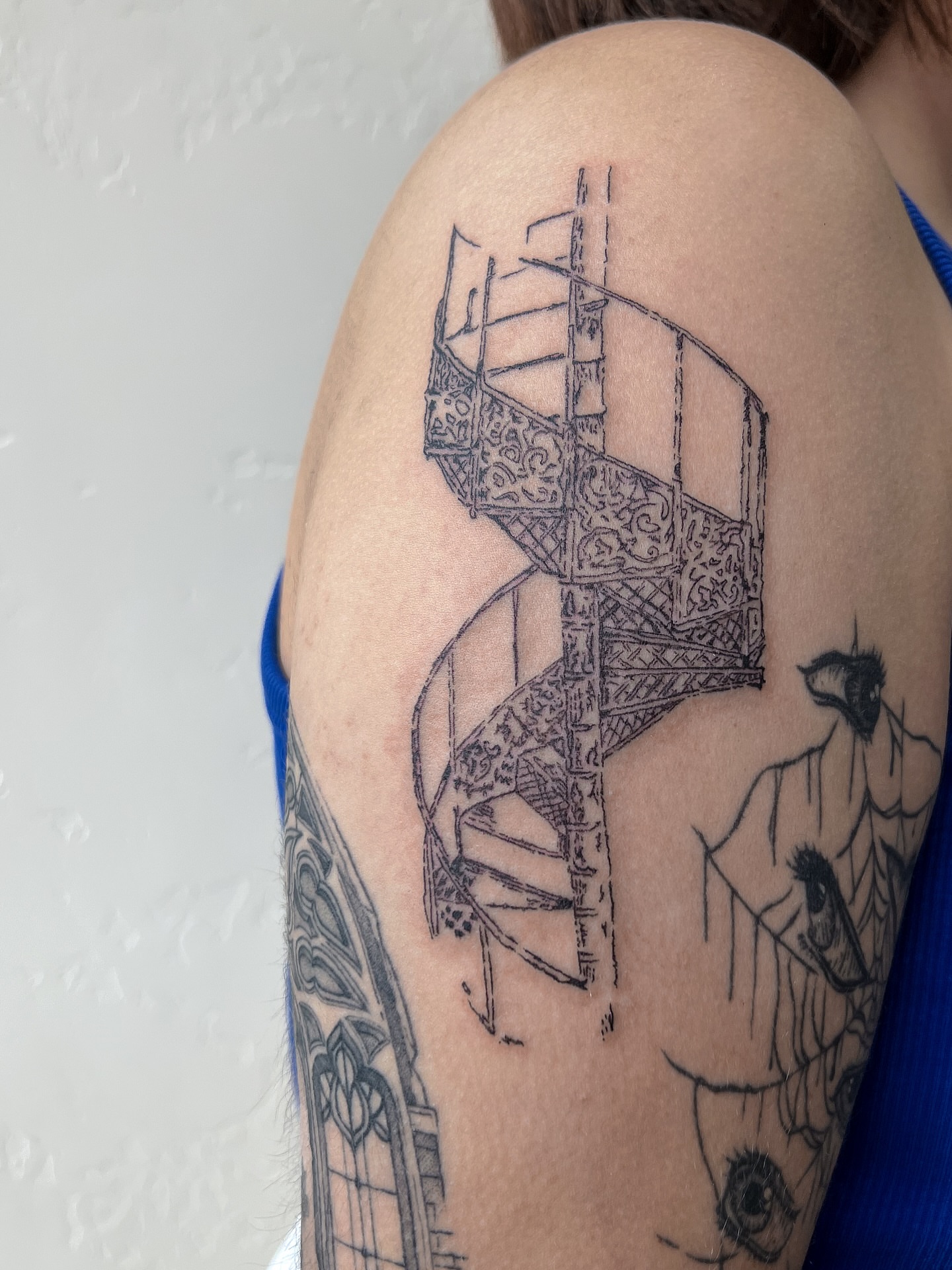 Spiral staircase black and grey tattoo on the shoulder by Abby Robinson