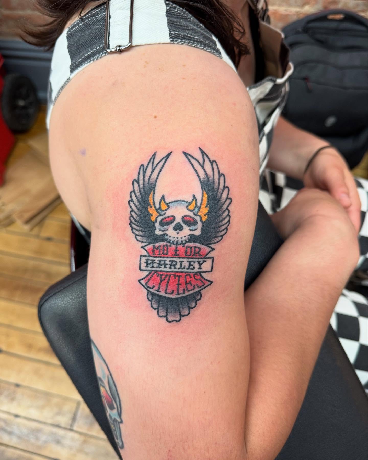 Skull with wings American traditional tattoo on the shoulder by Atom Aker