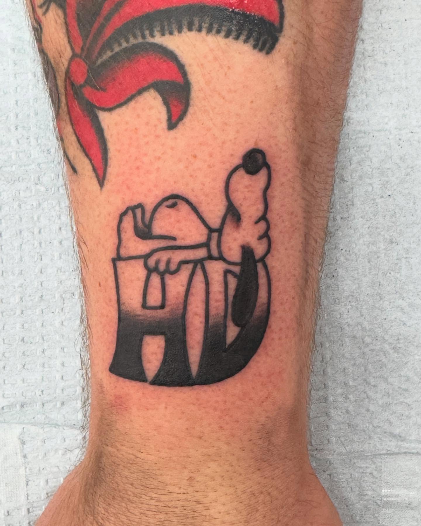 Snoopy and woodstock black and grey tattoo on the forearm by Atom Aker