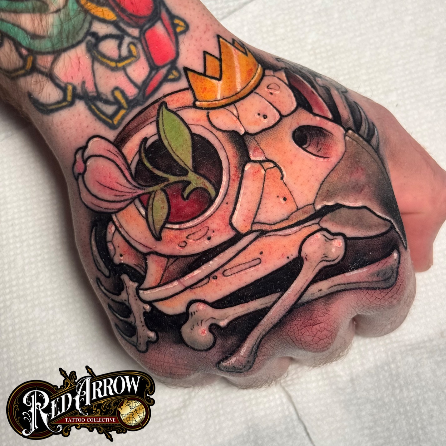 Skull with crown American traditional tattoo on the hand by 𝕽𝖊𝖉 𝕬𝖗𝖗𝖔𝖜 𝕿𝖆𝖙𝖙𝖔𝖔 𝕮𝖔𝖑𝖑𝖊𝖈𝖙𝖎𝖛𝖊, Troy, Michigan
