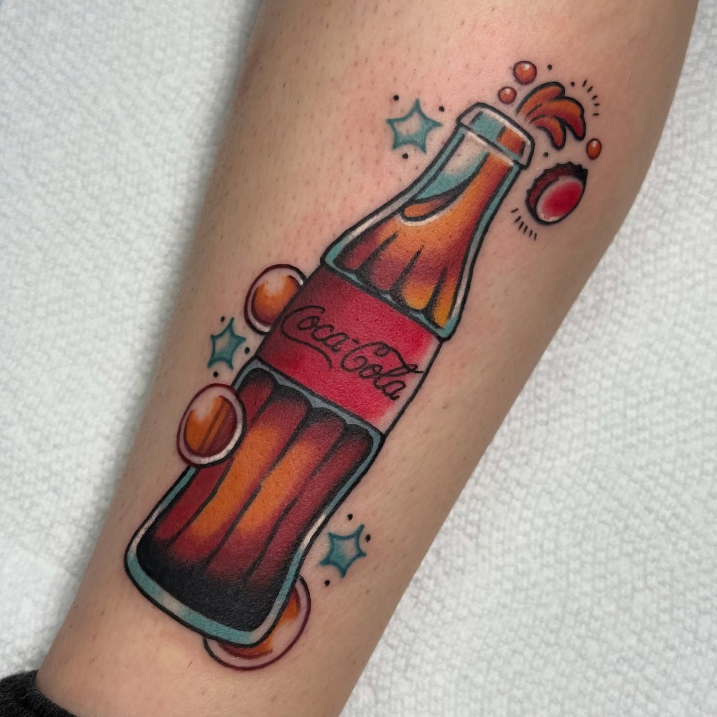 Coca-Cola bottle American traditional tattoo on the forearm by vic