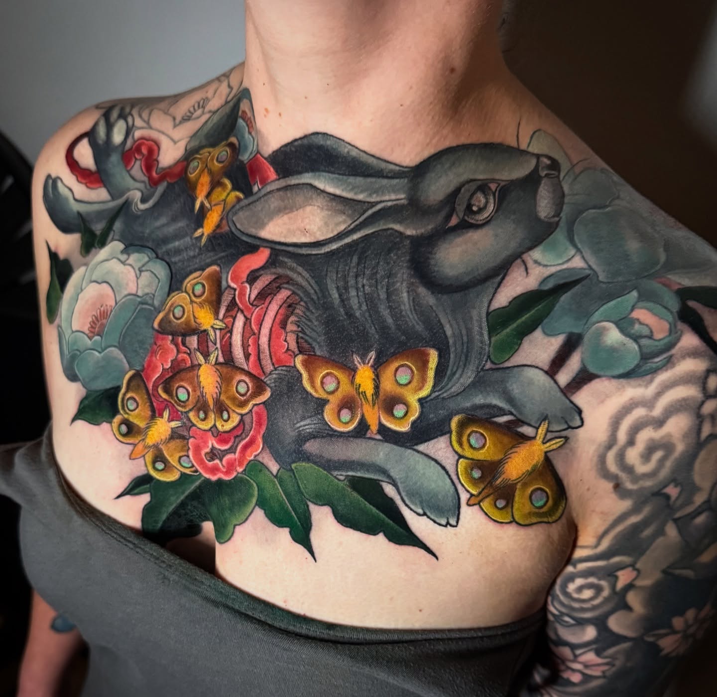 Rabbit and flowers American traditional tattoo on the chest by Jessica Brown
