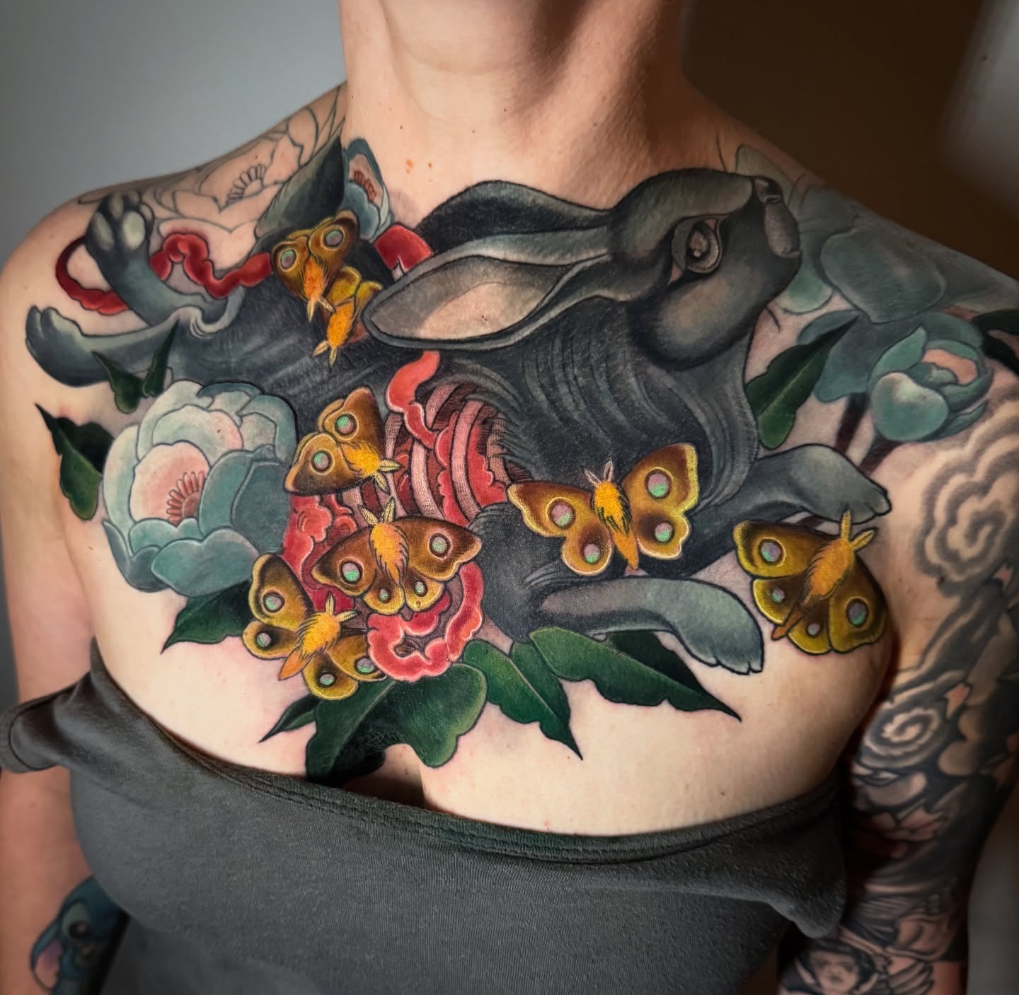 Elephant and butterflies American traditional tattoo on the chest by Jessica Brown