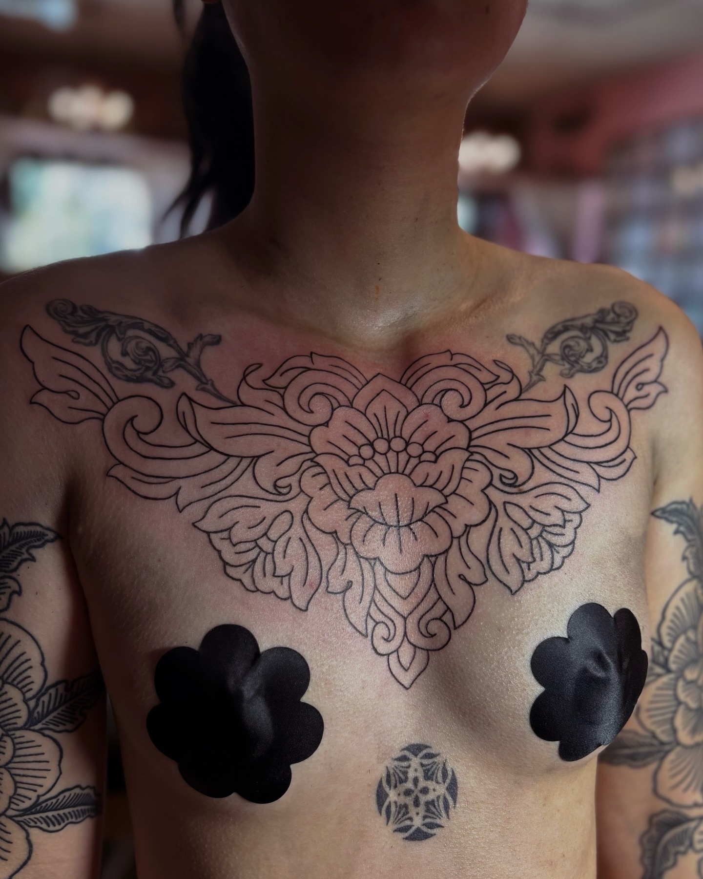 Floral mandala ornamental tattoo on the chest by Storm Smith