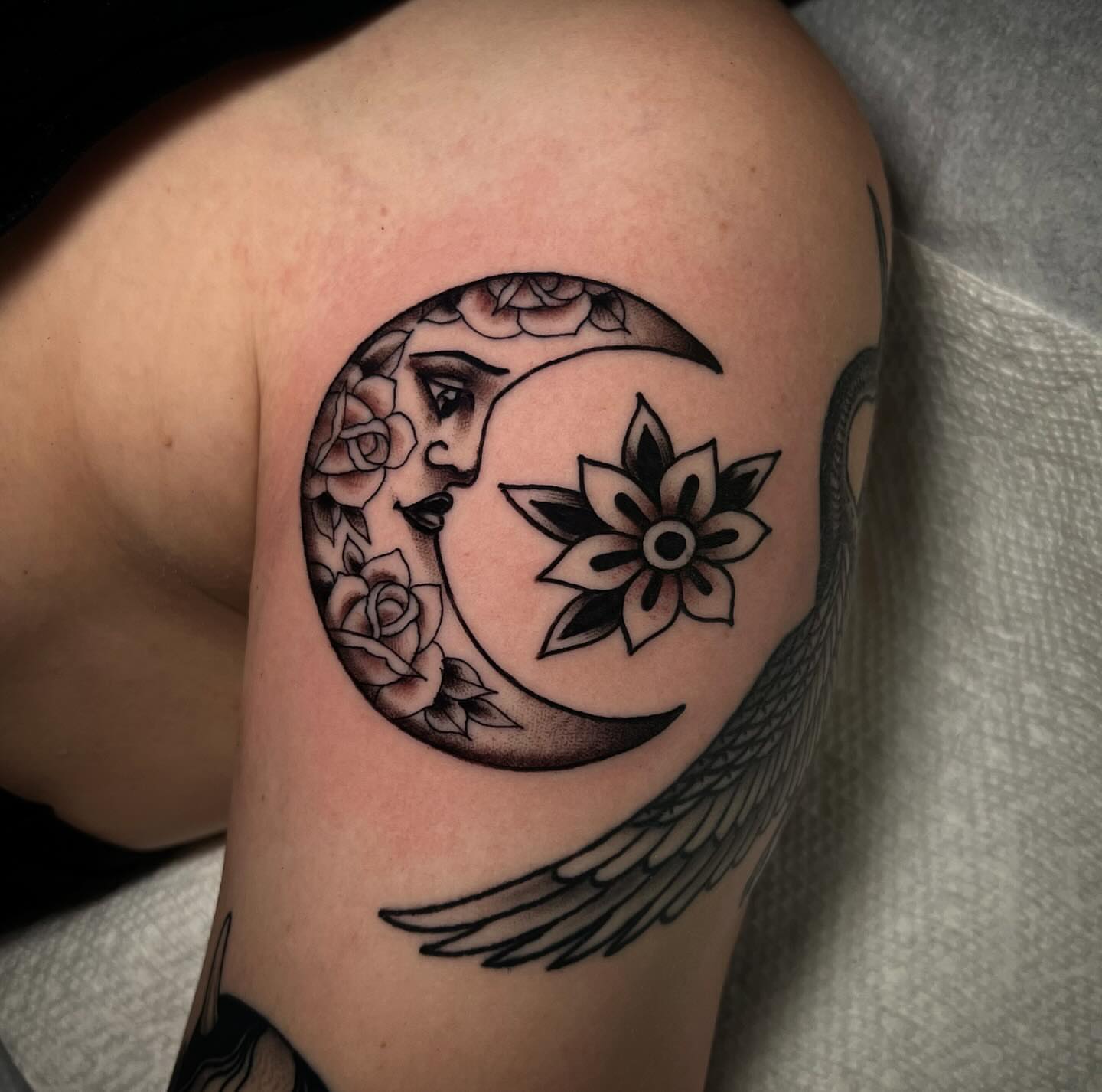 Moon and flowers geometric tattoo on the shoulder by Chris Romolini