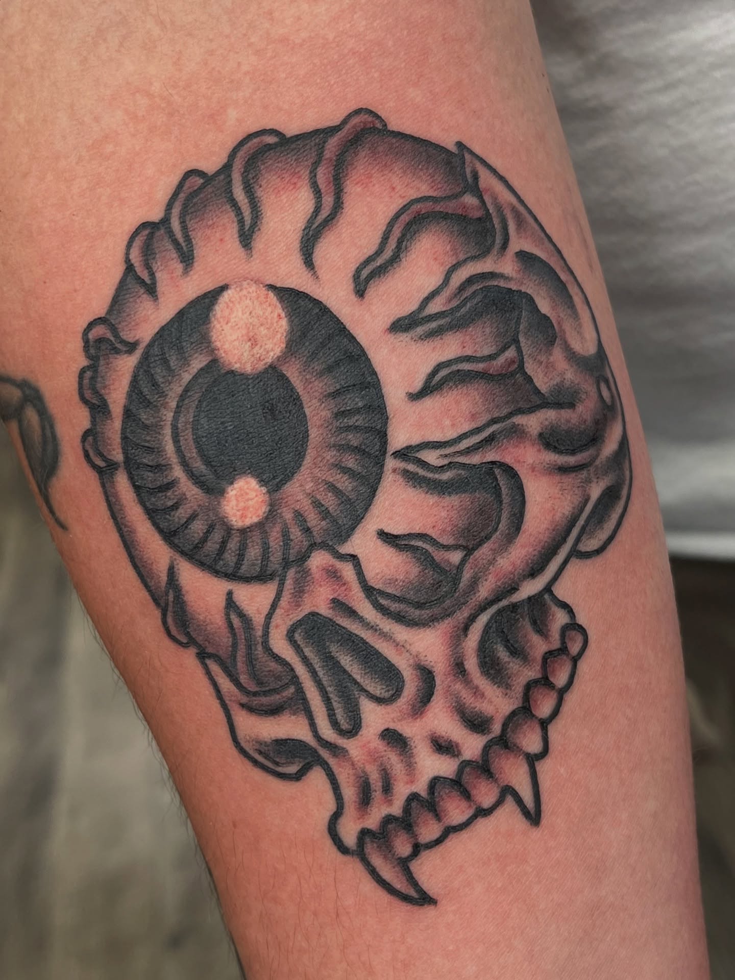 Skull with eye black and grey tattoo on the forearm by Steve Tiberi