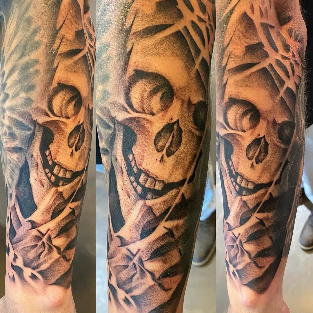 Skull with abstract background realism tattoo on the forearm by Cody Wolfe