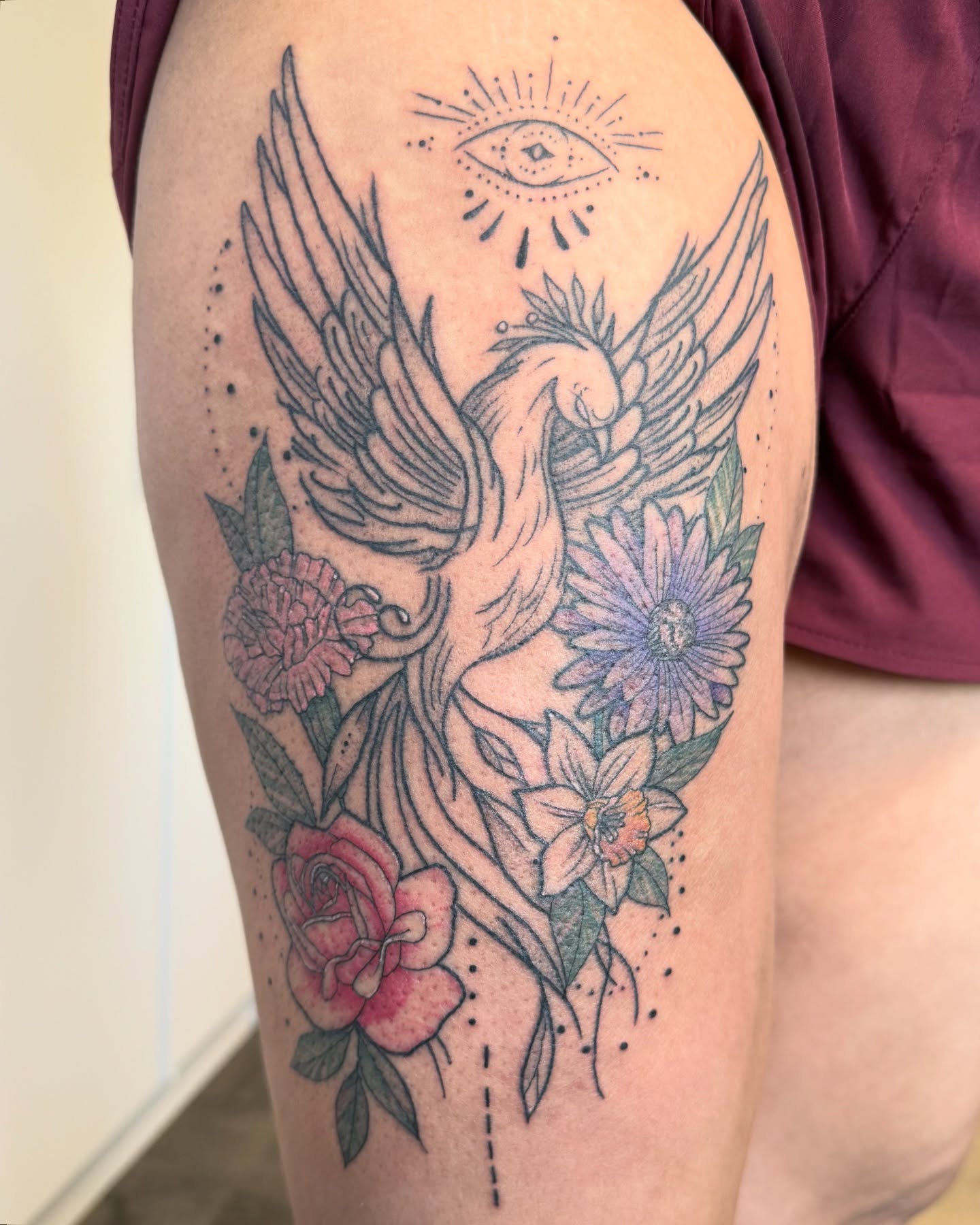 Phoenix and flowers dotwork tattoo on the thigh by Alexx Colombo