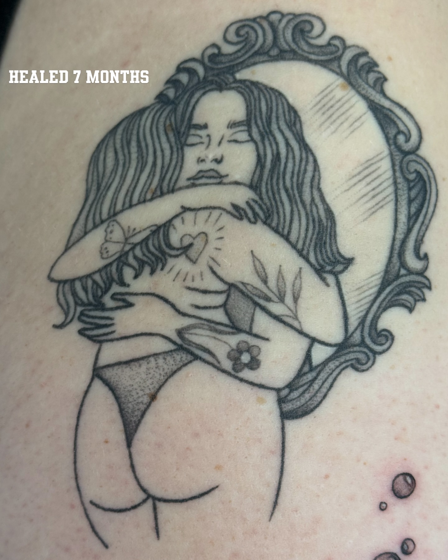 Mother and child black and grey tattoo on the thigh by Alexx Colombo
