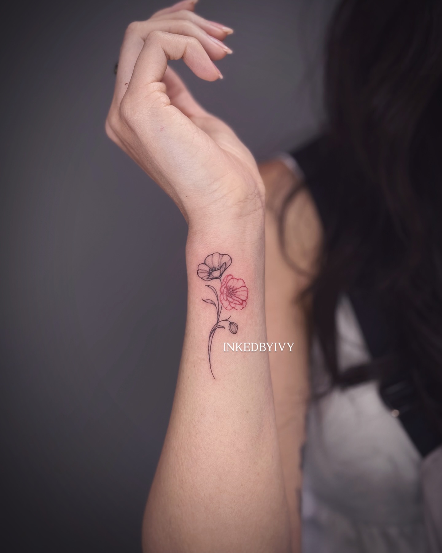 Flowers fine line tattoo on the forearm by IVY