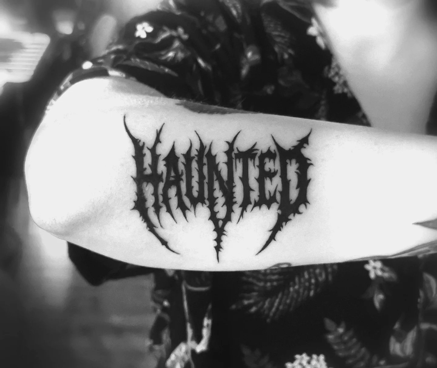 Haunted black and grey tattoo on the forearm by Ink of Winchester