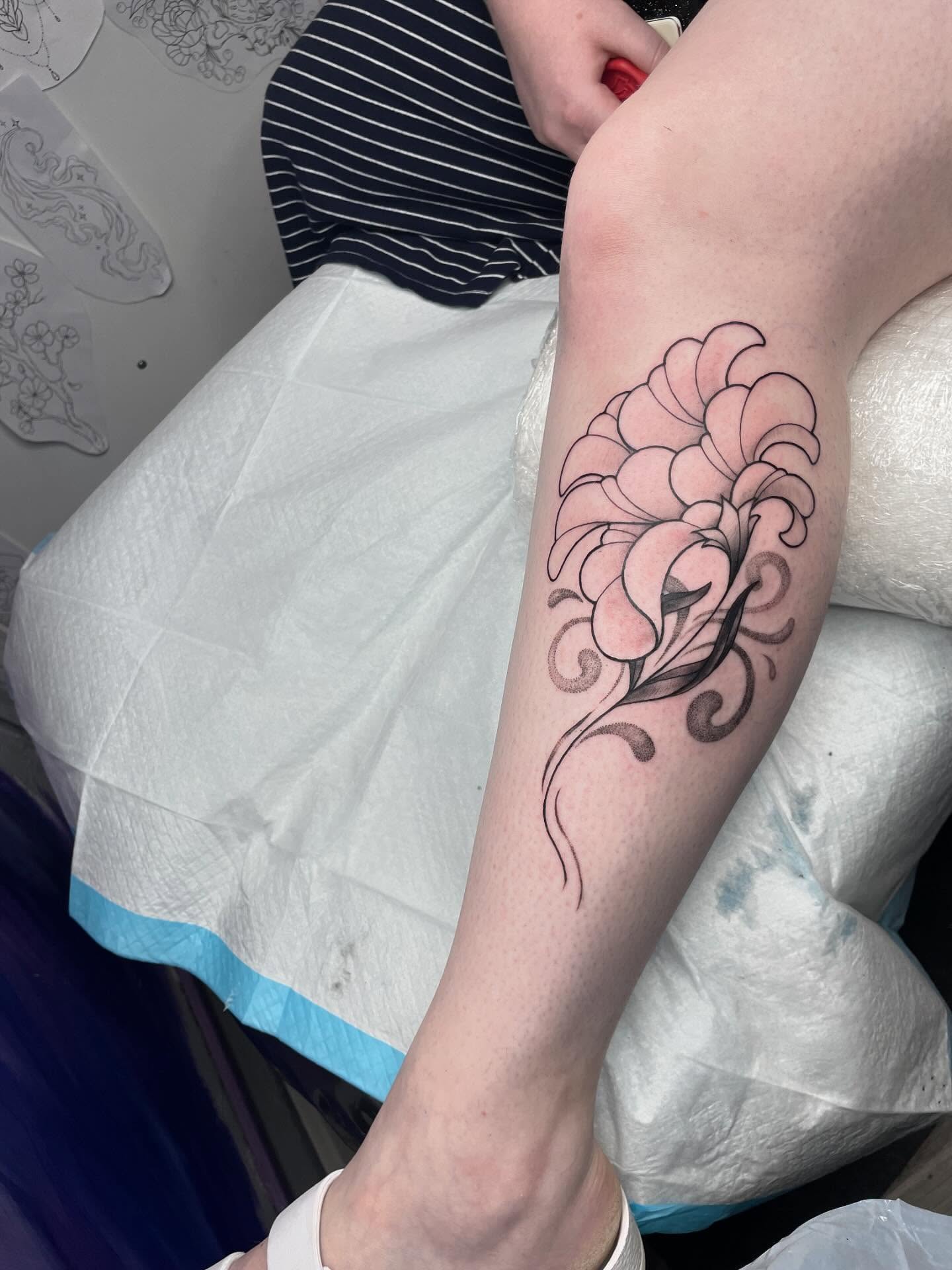 Floral black and grey tattoo on the forearm by Christin Baumgart