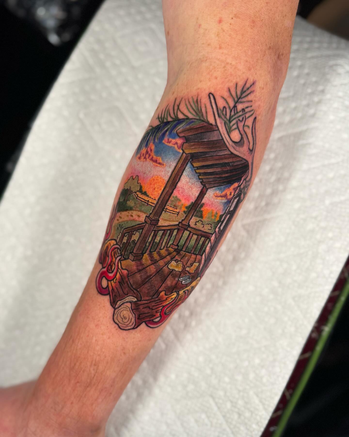 Porch swing sunset American traditional tattoo on the forearm by Anna Saveria