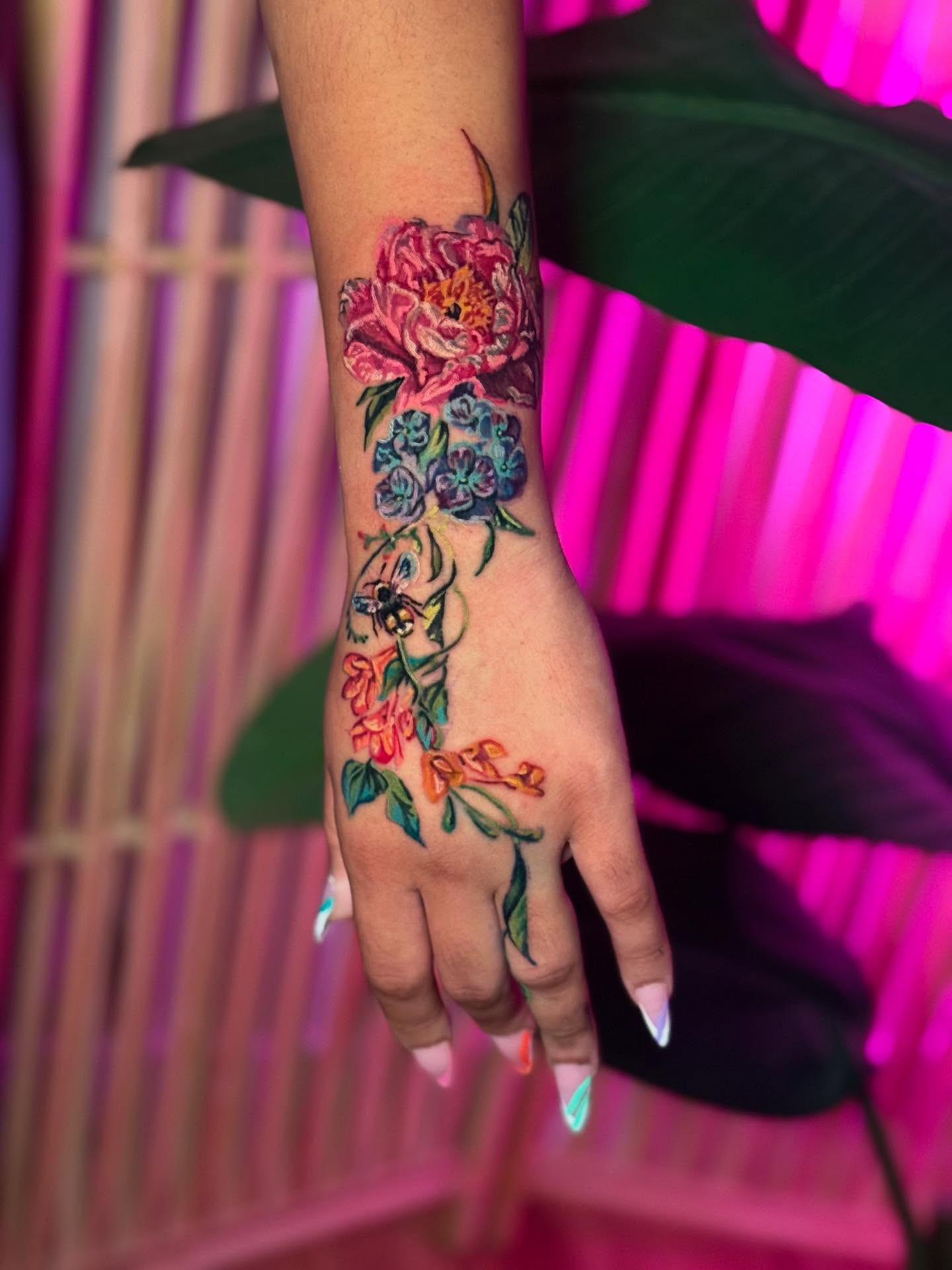 Floral bouquet watercolor tattoo on the hand by Colorful Tattoos by Cody Dean