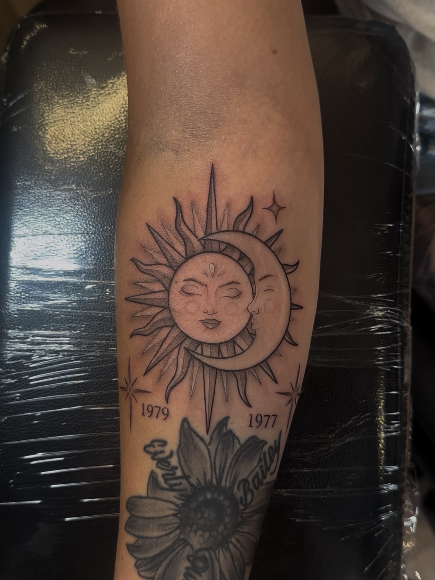 Sun and moon black and grey tattoo on the forearm by Priscilla Michels