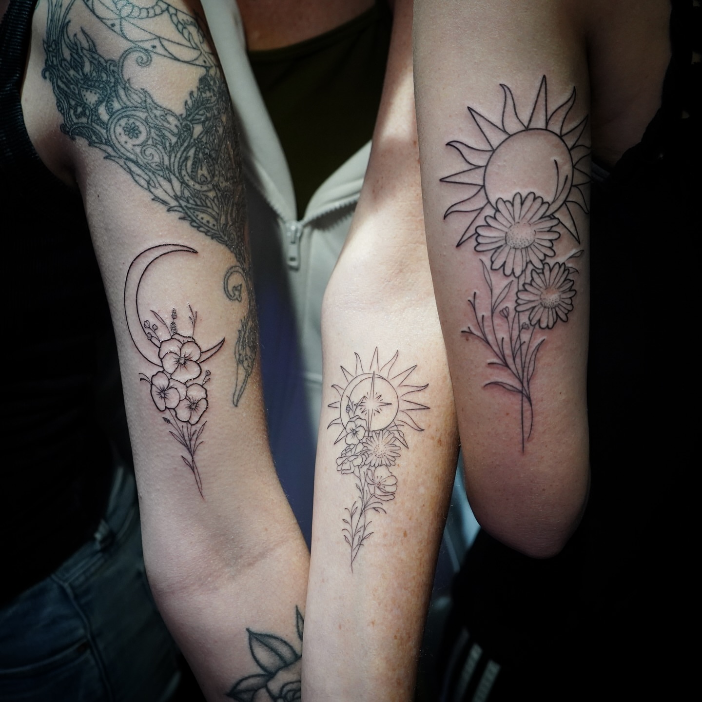 Sun and flowers black and grey tattoo on the forearm by Abel Ponce
