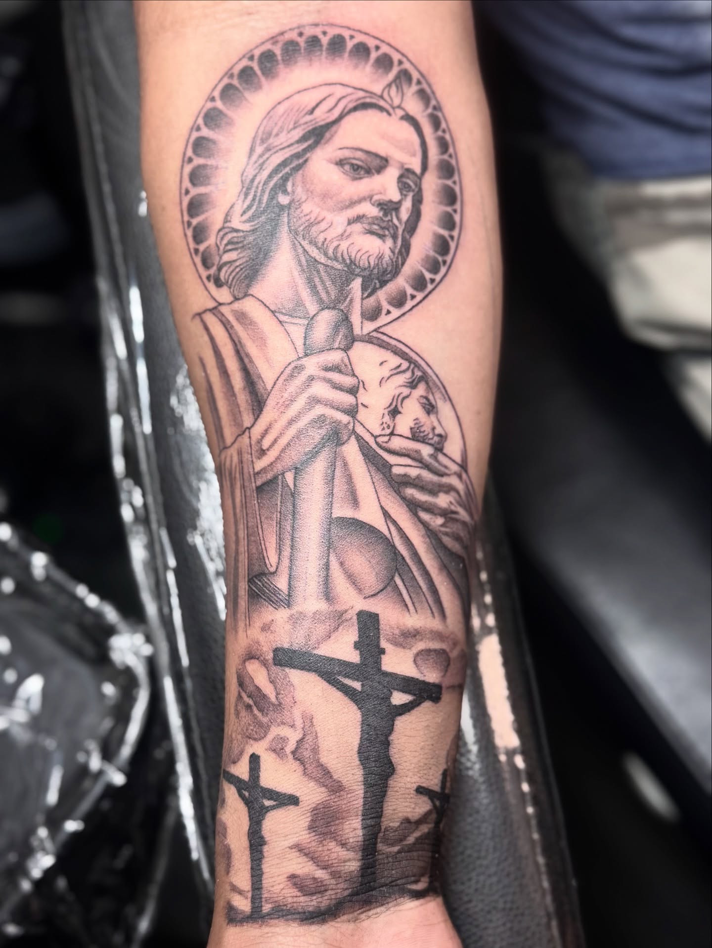 Religious figure black and grey tattoo on the forearm by Jess