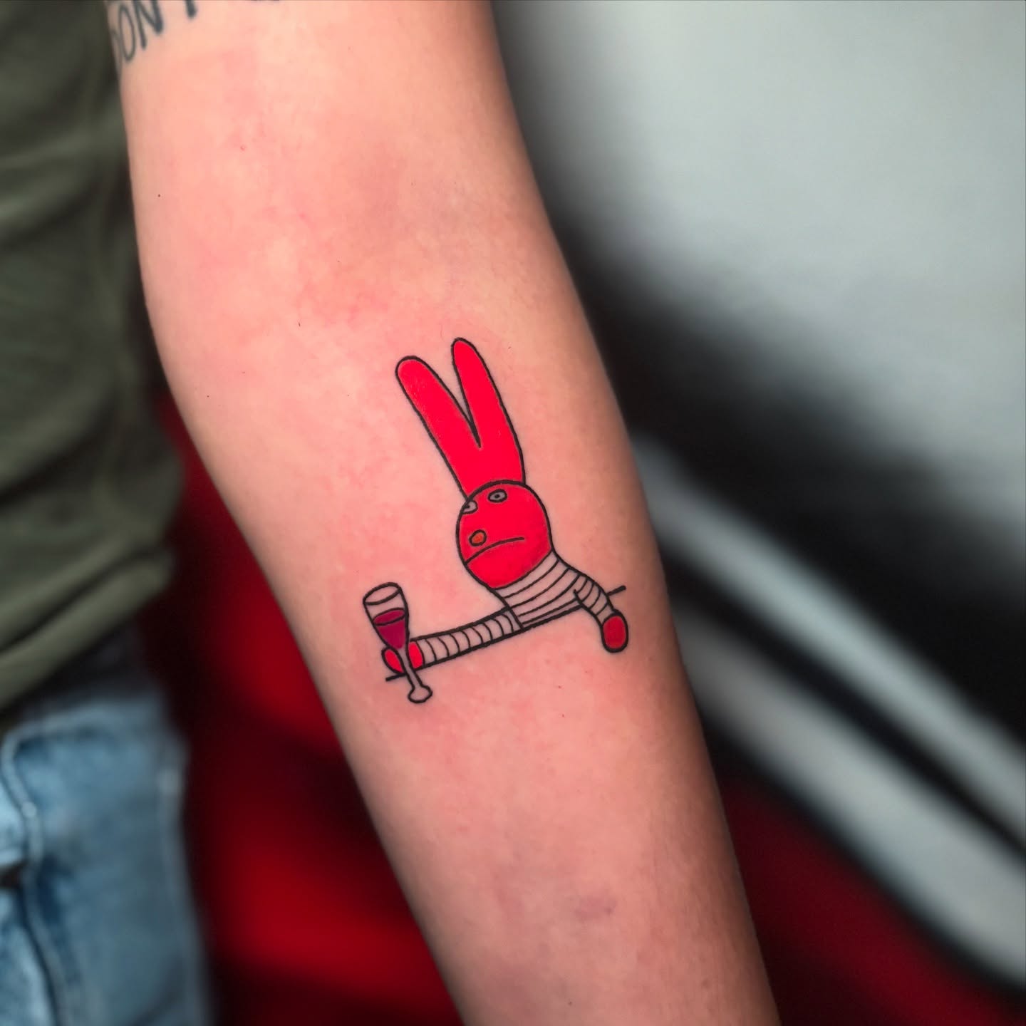 Red rabbit illustrative tattoo on the forearm by 𝕊𝕒𝕞 ☪︎ ִ ࣪𖤐 𐦍 ☾𖤓