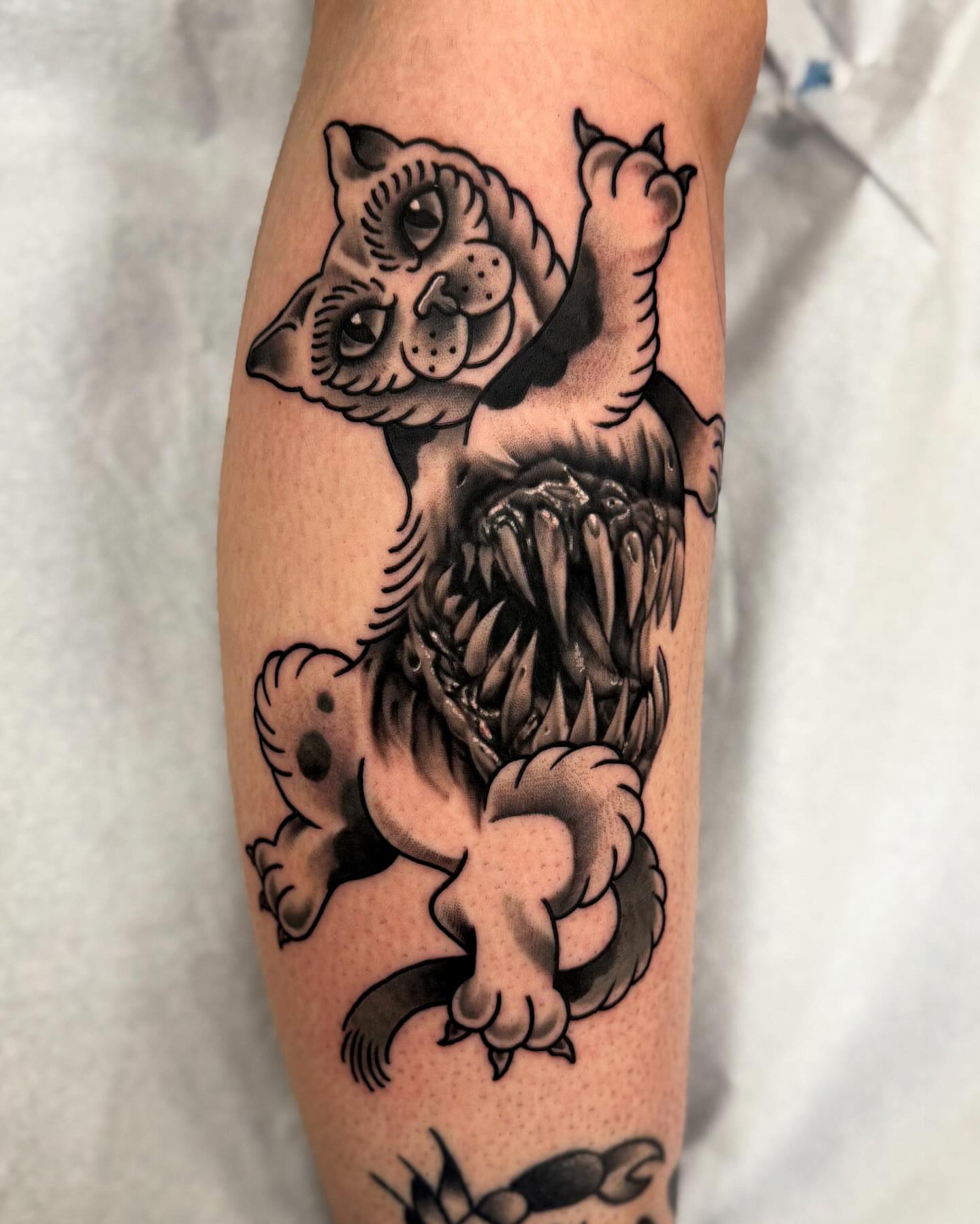 Cat American traditional tattoo on the forearm by Sam Babcock