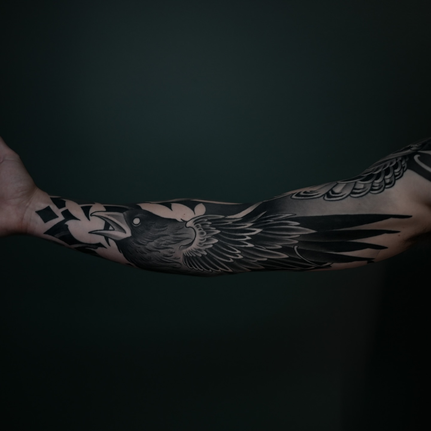 Crow black and grey tattoo on the forearm by Ryan Spencer - San Diego Tattoo Artist