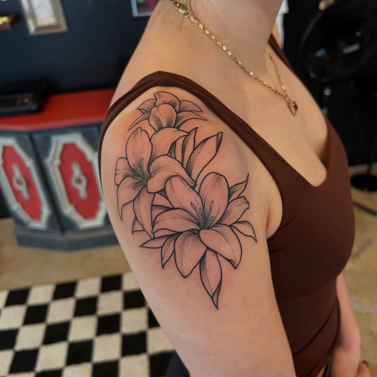 Lilies dotwork tattoo on the shoulder by Dom