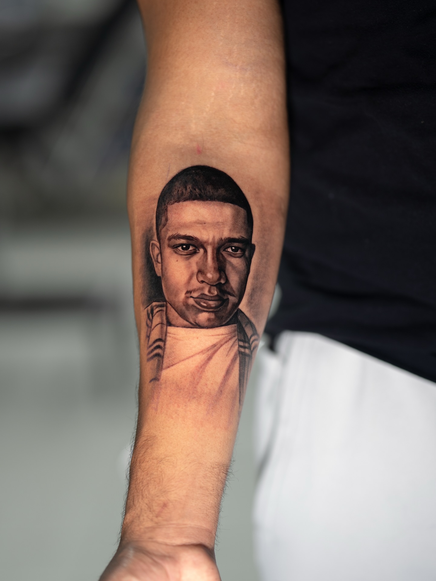 Portrait realism tattoo on the forearm by Joey Hella Tattoo Artist