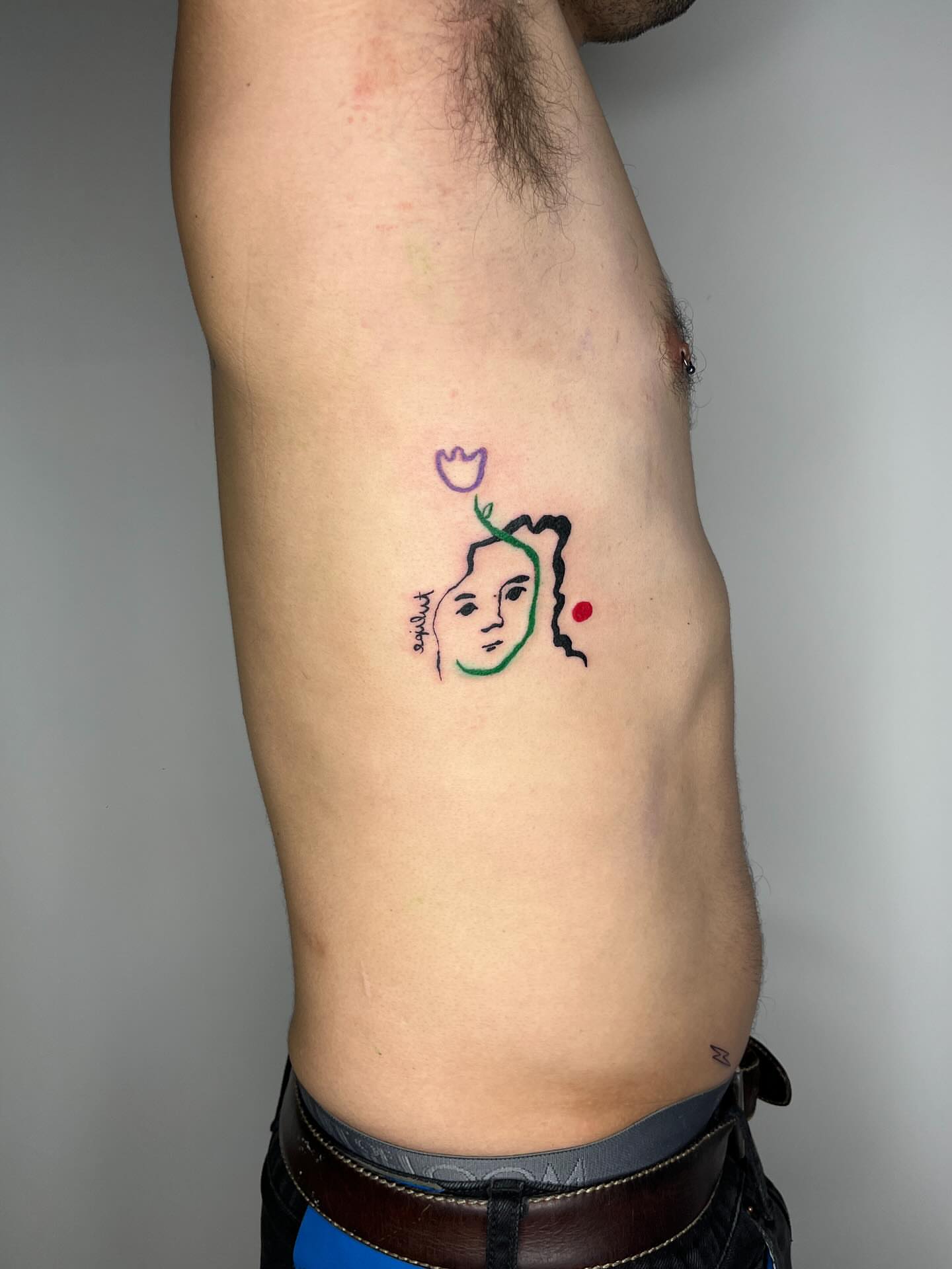 Abstract face minimalist tattoo on the ribs by tattoos by quin