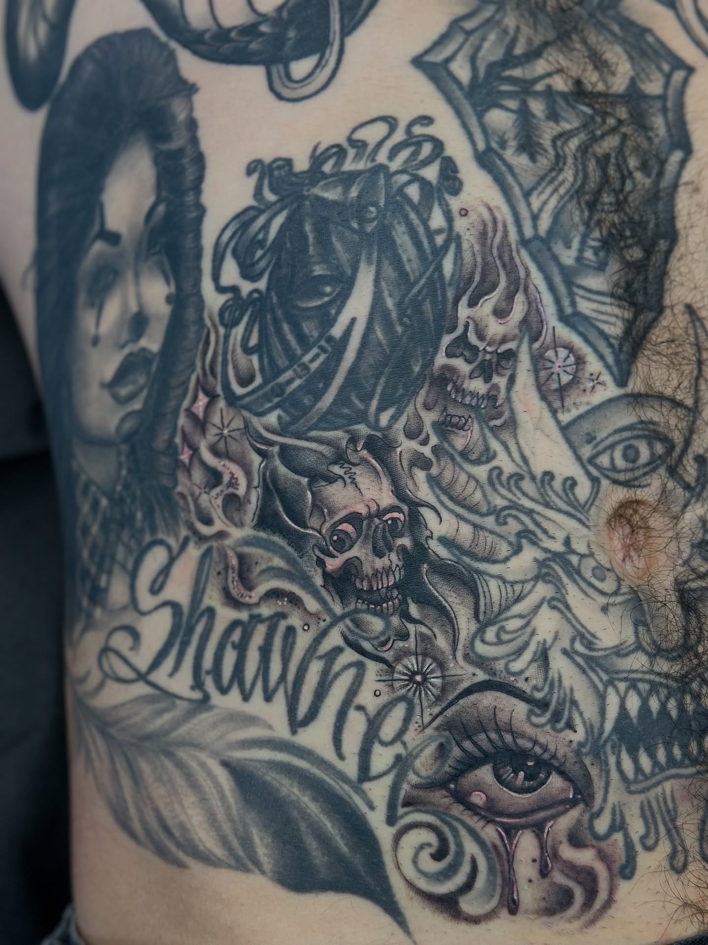 Portrait with skulls and eyes American traditional tattoo on the chest by Stevie O'Dell