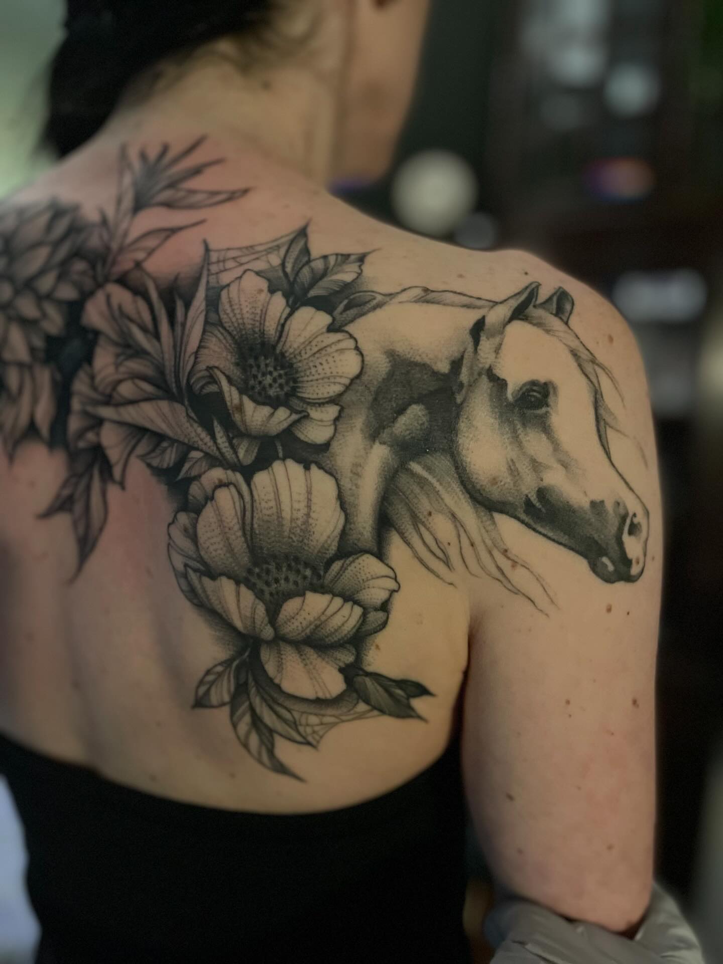 Horse and flowers realism tattoo on the shoulder by Jacob Kearney