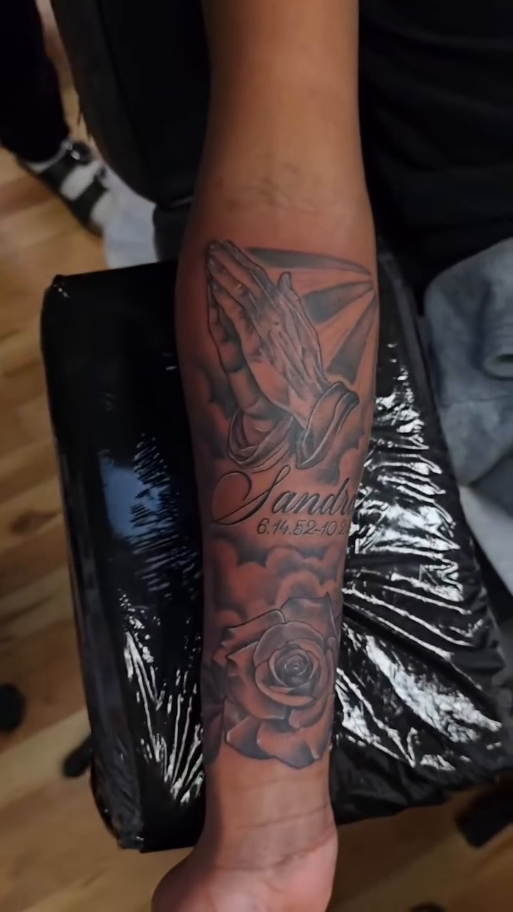 Praying hands with name and rose realism tattoo by Camuel Whaley