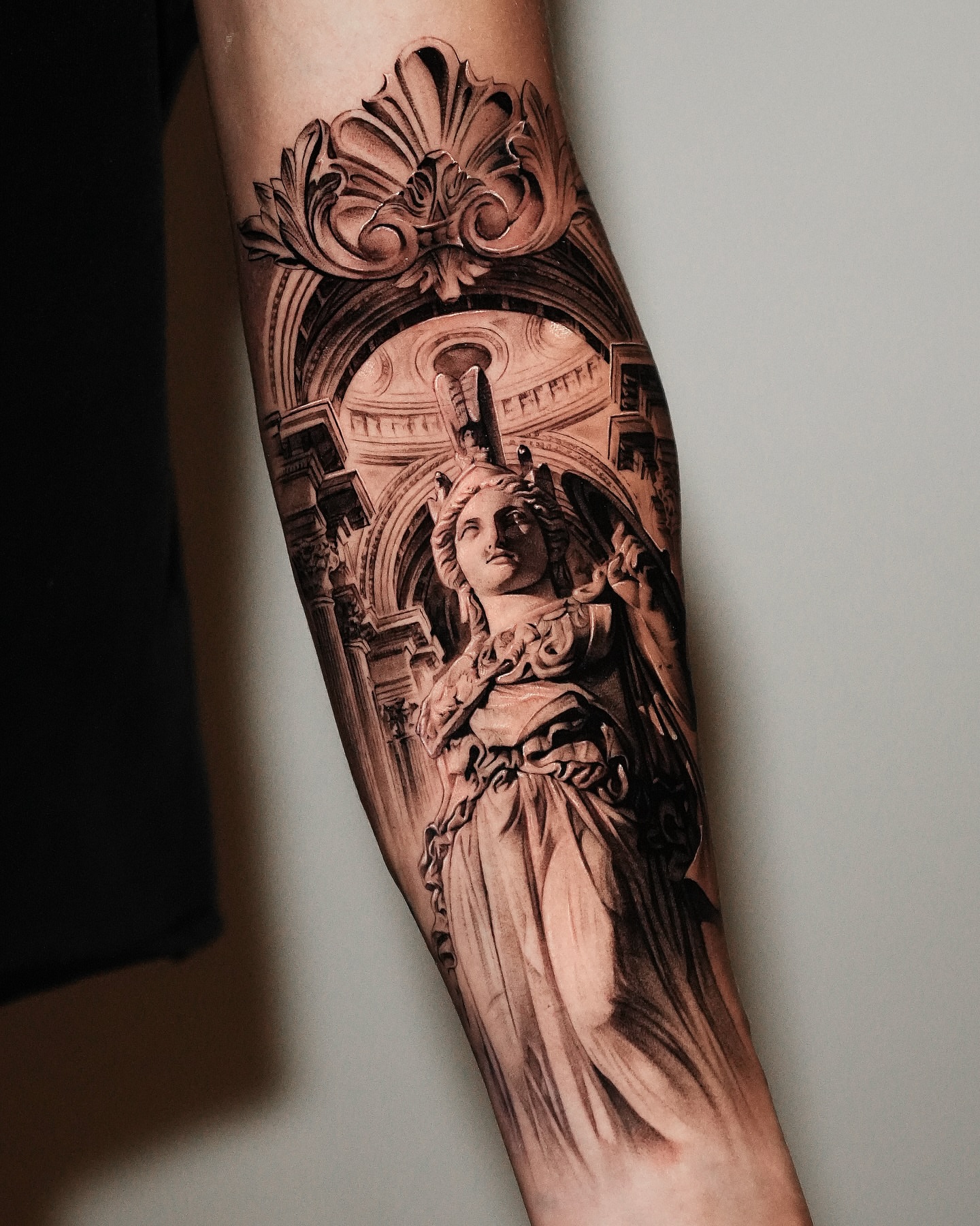 Statue realism tattoo on the forearm by Kid Needle