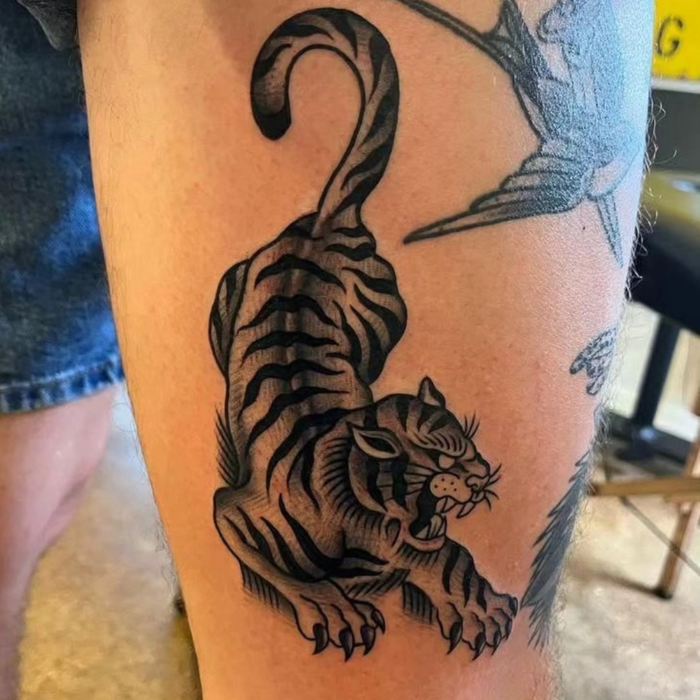 Tiger black and grey tattoo on the thigh by BZ Artistry