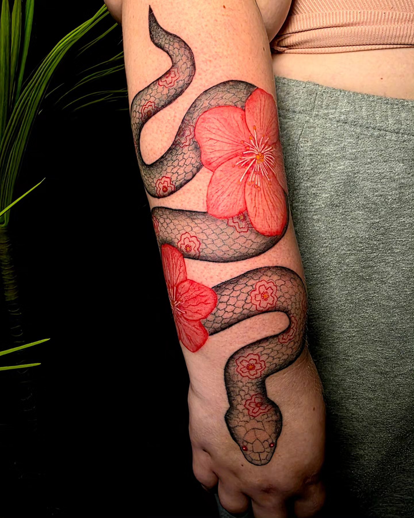Snake and flower realism tattoo on the forearm by 𝕷𝖚𝖈𝖎𝖉