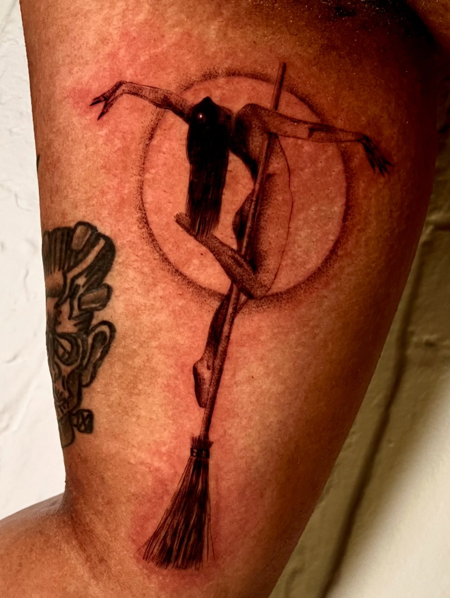 Broomstick witch black and grey tattoo on the thigh by Maddy Paige