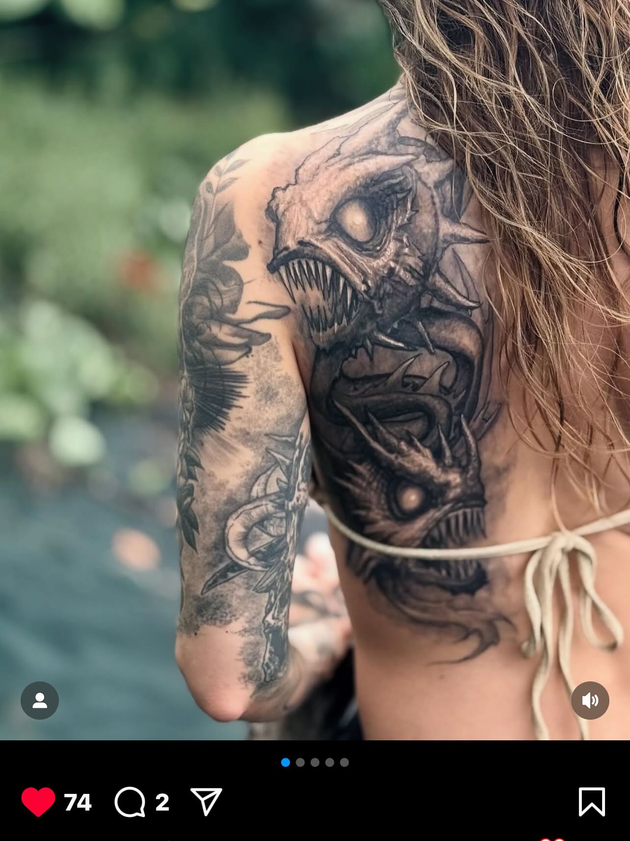 Monster heads dark realism tattoo on the shoulder by Paul Booth