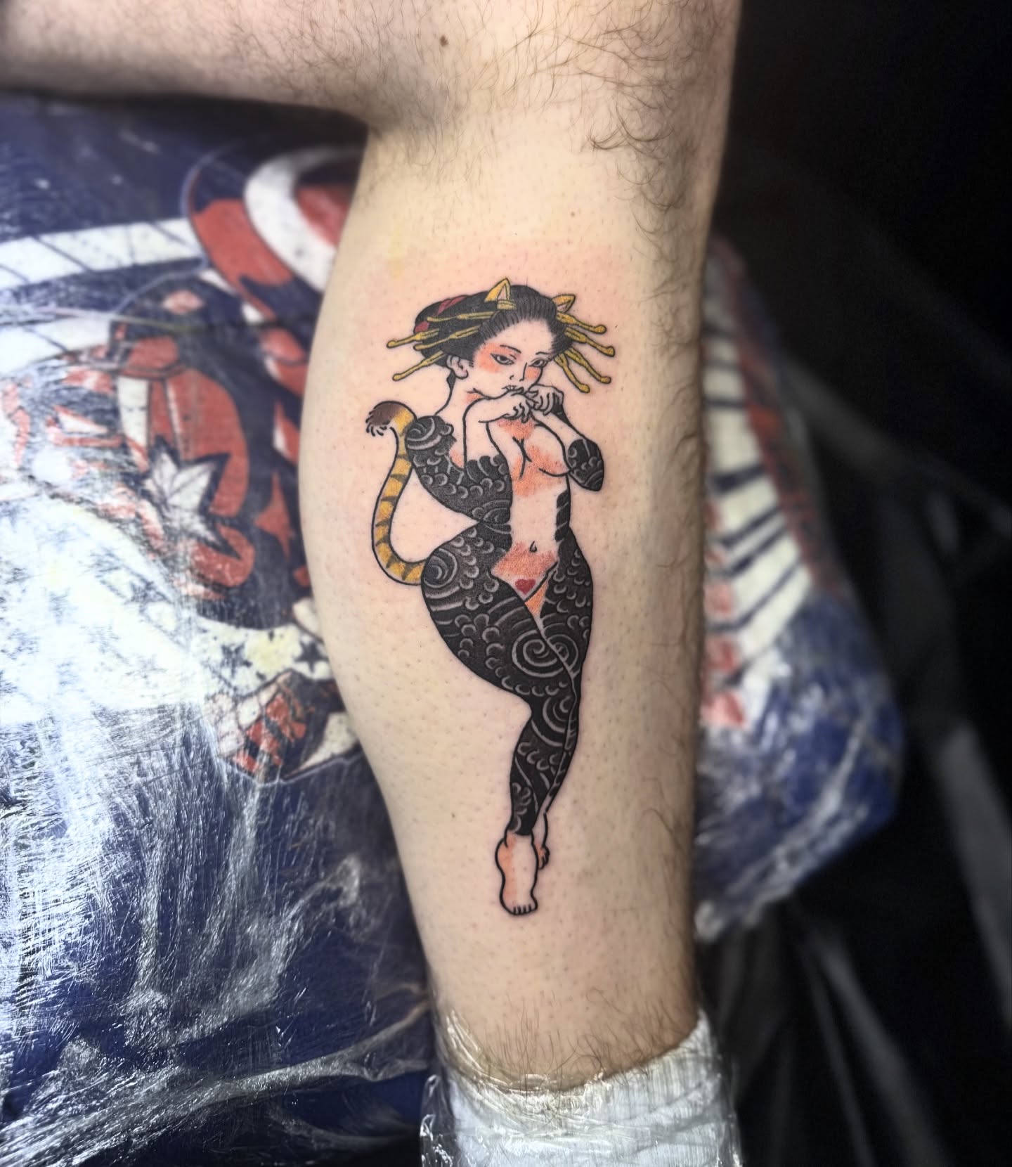 Mermaid playing flute American traditional tattoo on the forearm by Zack Yang, Houston, Texas