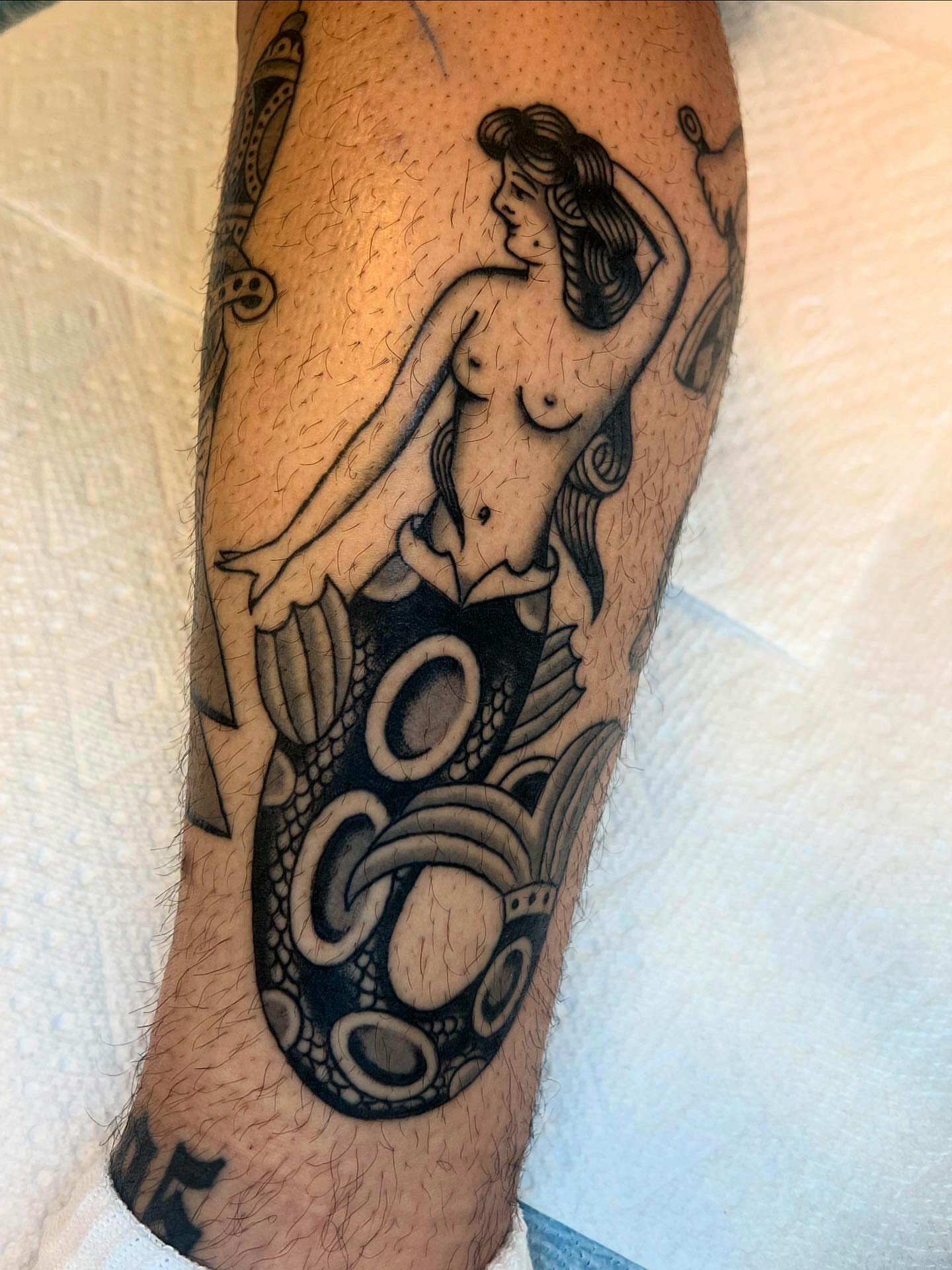Mermaid black and grey tattoo on the forearm by Syd Sayyah
