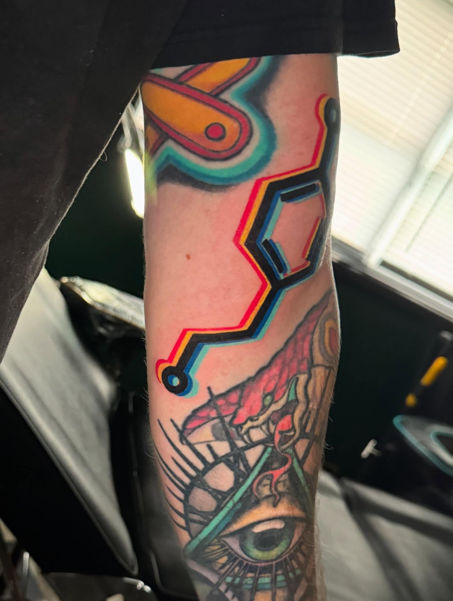 Eye and circuitry geometric tattoo on the forearm by Leslea Hipp