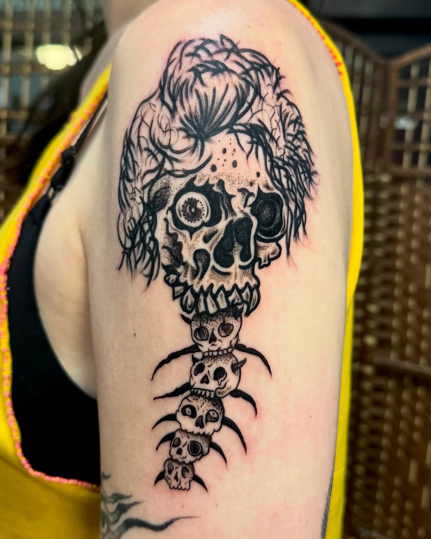 Skulls and hair black and grey tattoo on the forearm by Brandon