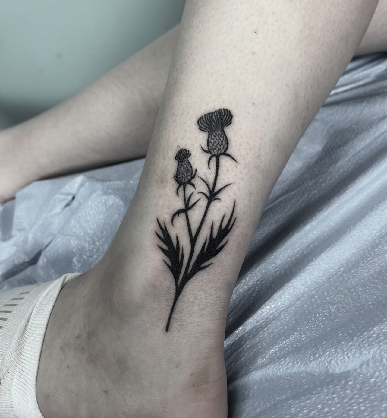 Thistle black and grey tattoo on the foot by ༒ boniandi༒