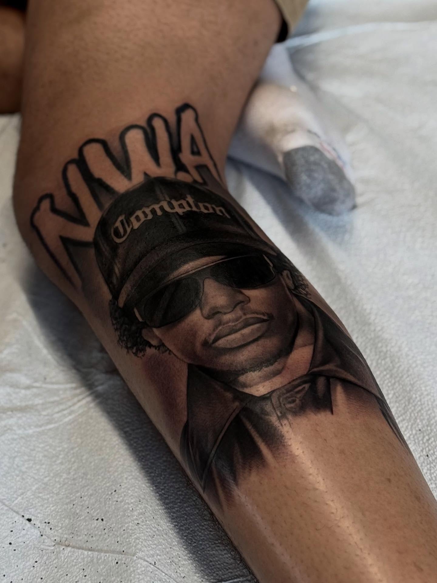 NWA member portrait realism tattoo on the forearm by Bryan ๐ฅ Loggins, Baton Rouge, Louisiana