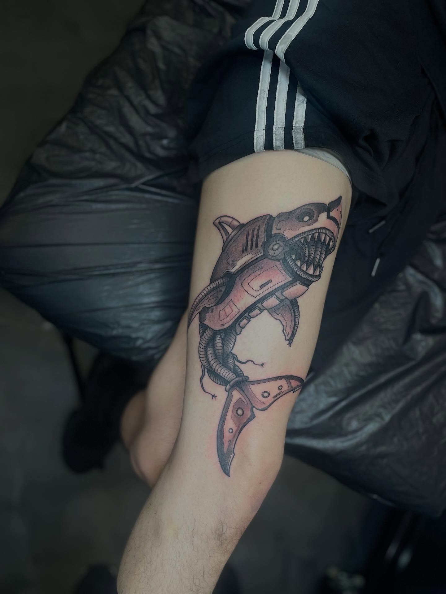 Mechanical shark geometric tattoo on the forearm by Nathan Evans