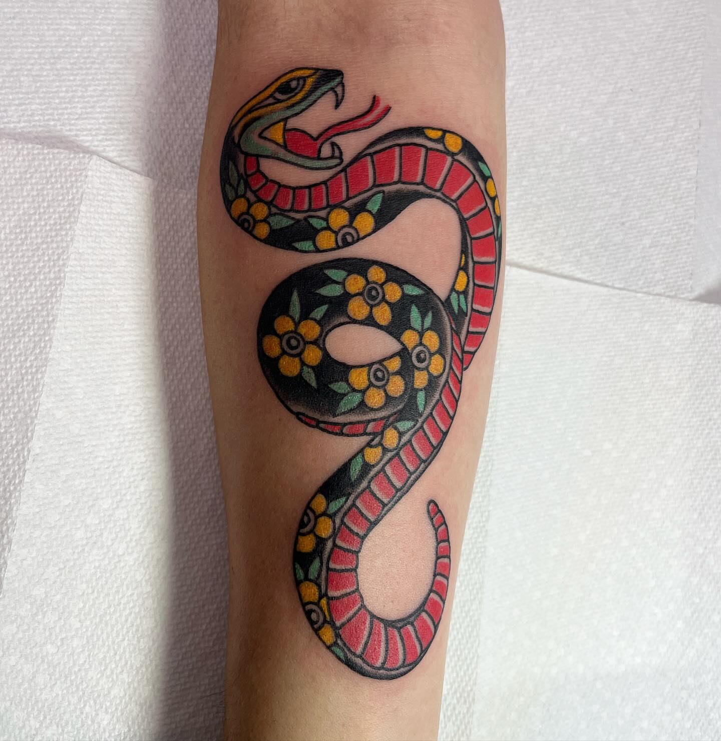 Snake American traditional tattoo on the forearm by Brian Mcfadden