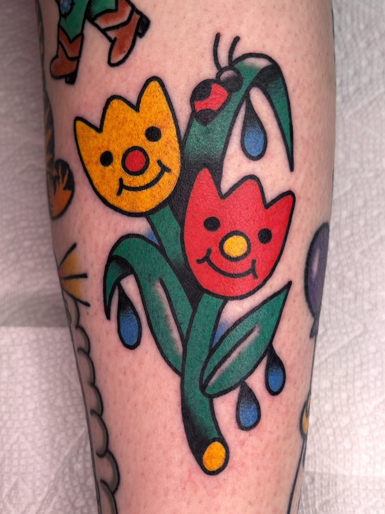 Tulips American traditional tattoo on the forearm by Robyn Fricke