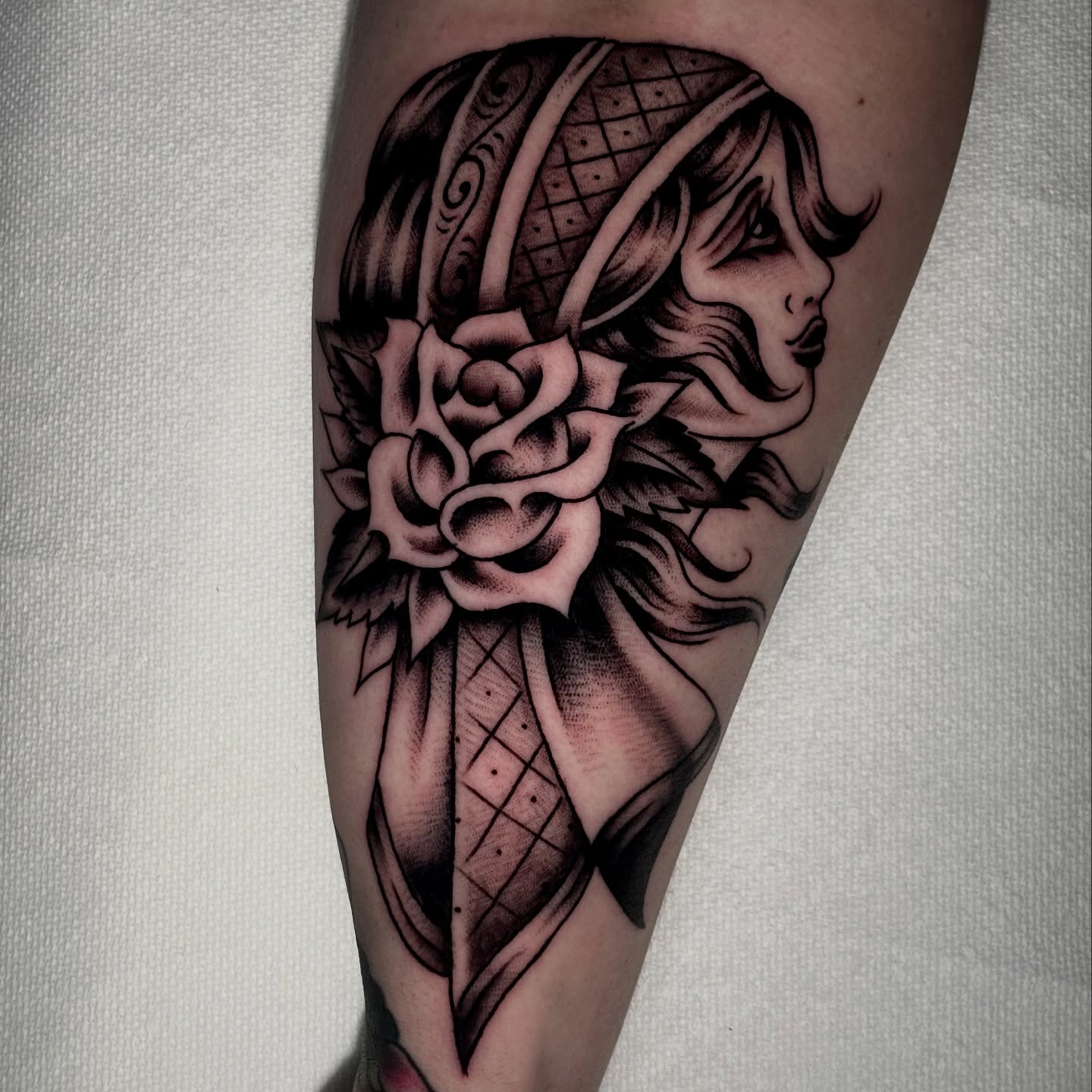Woman with rose realism tattoo on the forearm by Matt Elliott, Murfreesboro, Tennessee