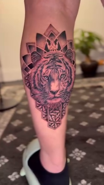 Tiger head with mandala realism tattoo on the leg by Ivy lee