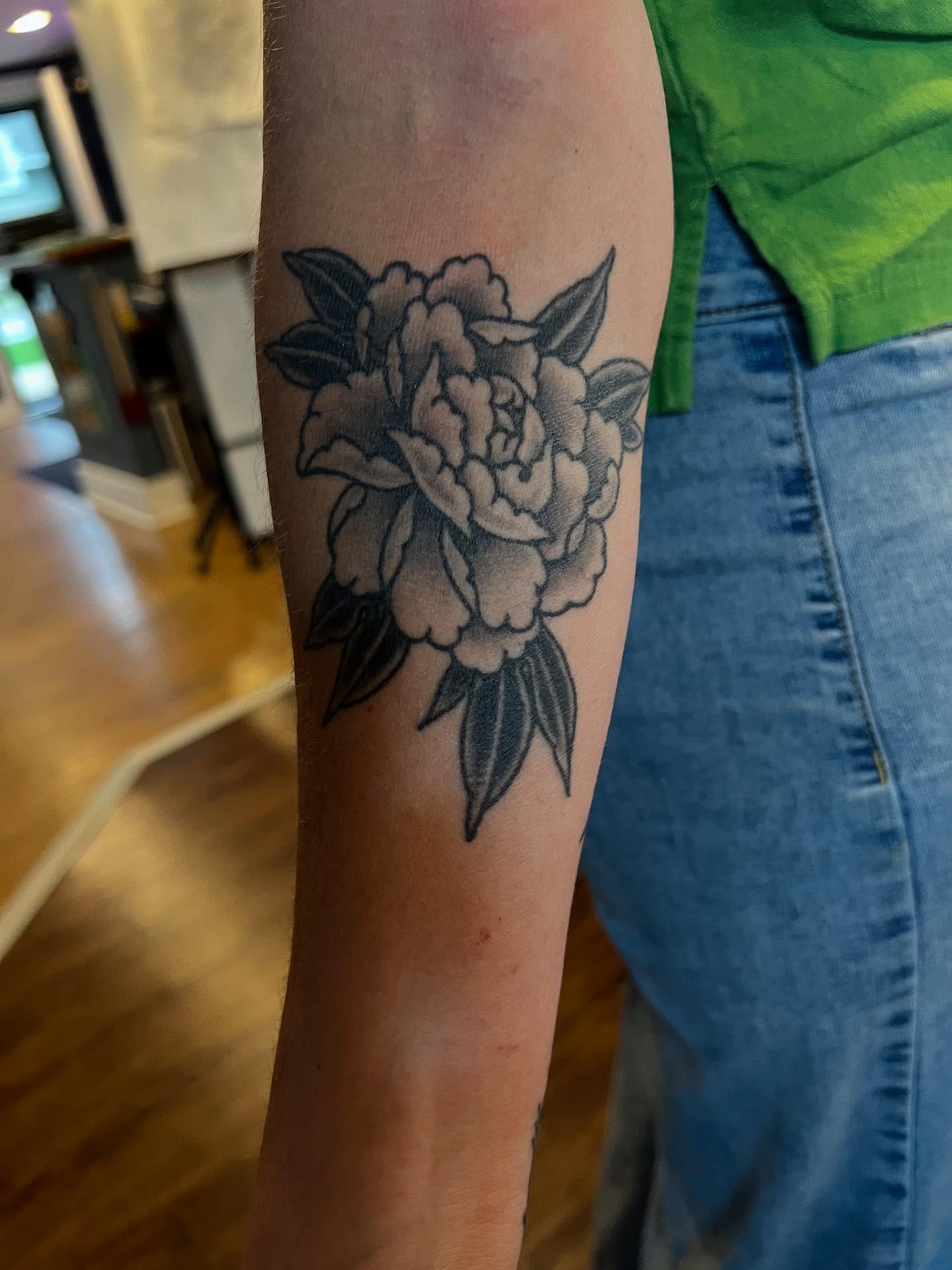 Peony black and grey tattoo on the forearm by Josh Albers